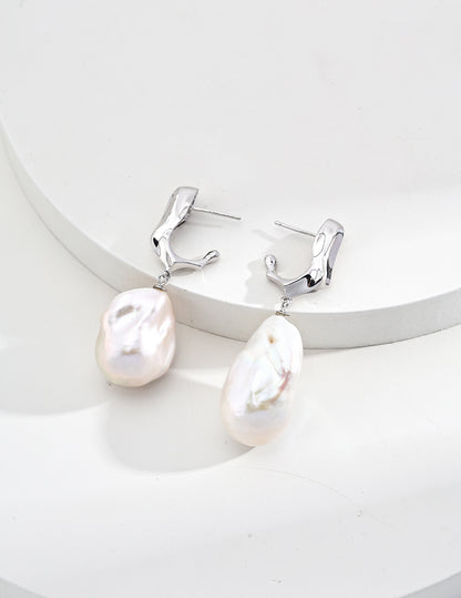 Elegant baroque pearl drop earrings with a silver fluid design, perfect for weddings, beach getaways, or vacation looks