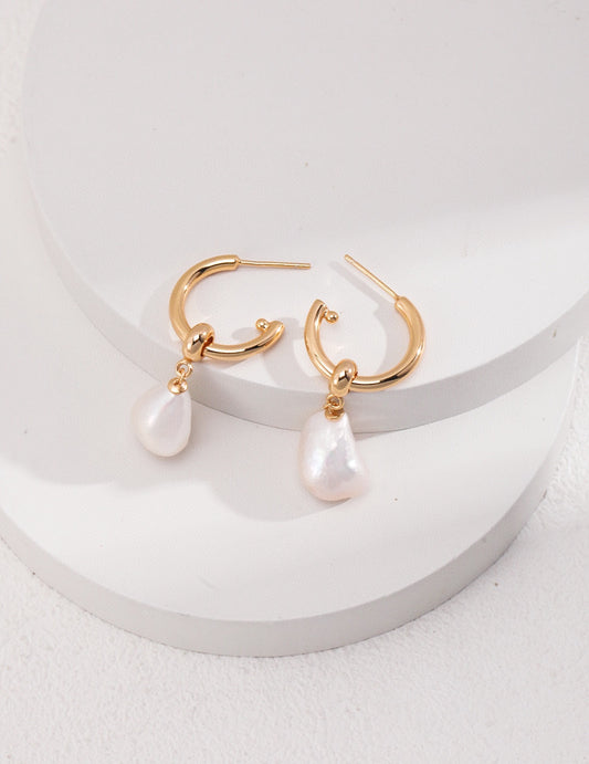 Two-piece gold hoop earrings with detachable baroque pearls, crafted for dual-purpose wear, ideal for both casual and formal looks