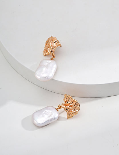 Leaf-inspired gold and silver earrings with natural baroque pearl accents, perfect for adding a touch of nature-inspired elegance